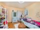 A bedroom featuring hardwood floors, a window, and light yellow walls at 4100 Sudbury Rd, Charlotte, NC 28205