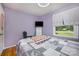 A bedroom featuring hardwood floors, a window and light purple walls at 4100 Sudbury Rd, Charlotte, NC 28205