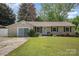 Charming single-story home featuring manicured lawn and inviting front porch at 4100 Sudbury Rd, Charlotte, NC 28205