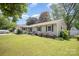 Well-kept single story home with green lawn and a charming walkway leading to the front door at 4100 Sudbury Rd, Charlotte, NC 28205