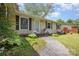 Charming single-story home featuring a well-maintained lawn and inviting front porch at 4100 Sudbury Rd, Charlotte, NC 28205