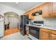 Functional kitchen featuring an oven, wooden cabinets, and a granite countertop at 4100 Sudbury Rd, Charlotte, NC 28205