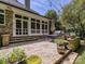 Charming backyard featuring a stone patio, outdoor seating, grill, and lush landscaping at 4608 Morrowick Rd, Charlotte, NC 28226