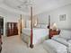Spacious bedroom featuring a four-poster bed, trey ceilings, and sitting area at 4608 Morrowick Rd, Charlotte, NC 28226