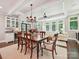 Dining area flowing to living room with bar and wine cooler and lots of windows at 4608 Morrowick Rd, Charlotte, NC 28226