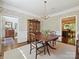 Spacious dining room showcasing a chandelier, hardwood floors, and views into the kitchen and other living spaces at 4608 Morrowick Rd, Charlotte, NC 28226