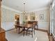 Elegant dining room featuring a chandelier, wallpaper, and ample space for entertaining at 4608 Morrowick Rd, Charlotte, NC 28226