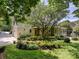 Exterior home shot with lush landscaping, a tree lined lot and a partial view of outdoor patio and attached garage at 4608 Morrowick Rd, Charlotte, NC 28226