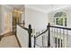 Elegant foyer featuring a staircase with white railings and a decorative chandelier at 4608 Morrowick Rd, Charlotte, NC 28226
