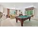 Entertaining game room with pool table, comfortable seating, and bright windows offering natural light at 4608 Morrowick Rd, Charlotte, NC 28226