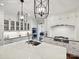 Modern kitchen with white cabinets, stone countertops and a large island with sink at 4608 Morrowick Rd, Charlotte, NC 28226