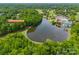 Aerial shot featuring 4609 Rounding Run Rd next to a lake and golf course with mature trees at 4609 Rounding Run Rd, Charlotte, NC 28277