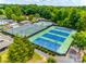 Aerial view of community tennis courts surrounded by lush greenery, providing an active lifestyle at 4609 Rounding Run Rd, Charlotte, NC 28277