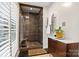 Beautiful bathroom with dark tile flooring and tiled walk-in shower with glass enclosure at 4609 Rounding Run Rd, Charlotte, NC 28277