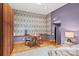 Stylish bedroom features a unique accent wall, natural light, and a dining set at 4609 Rounding Run Rd, Charlotte, NC 28277