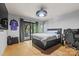 Modern bedroom with sliding glass door to outdoor deck, unique light fixture and wooden floors at 4609 Rounding Run Rd, Charlotte, NC 28277