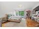 Inviting bedroom with bright natural light, outdoor access, and dedicated desk and shelving space at 4609 Rounding Run Rd, Charlotte, NC 28277