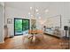 Elegant dining room featuring modern lighting, stylish furniture, and a view of the outdoors, great for gatherings at 4609 Rounding Run Rd, Charlotte, NC 28277