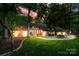Charming home featuring stone accents, a well-manicured lawn, and lush landscaping with trees surrounding the property at 4609 Rounding Run Rd, Charlotte, NC 28277