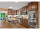 Well-equipped kitchen with stainless steel appliances, granite countertops, a butcher block island, and hardwood floors at 4609 Rounding Run Rd, Charlotte, NC 28277
