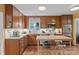 Well-lit kitchen featuring wooden cabinets, granite countertops, a butcher block island, stainless steel appliances, and hardwood floors at 4609 Rounding Run Rd, Charlotte, NC 28277