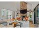 Cozy living room featuring a stone fireplace, comfortable seating, and built-in shelves for a relaxing atmosphere at 4609 Rounding Run Rd, Charlotte, NC 28277