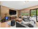 Cozy living room with comfortable seating, large TV, and sliding doors to the outdoors at 4609 Rounding Run Rd, Charlotte, NC 28277