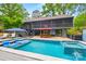 Backyard pool with sundeck and seating, plus exterior view of multi-story home, deck and staircase at 4609 Rounding Run Rd, Charlotte, NC 28277