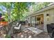 Outdoor deck with seating and a view of lush trees at 50 Honeysuckle Woods, Lake Wylie, SC 29710