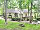 Charming home with a two-car garage surrounded by lush greenery and trees at 50 Honeysuckle Woods, Lake Wylie, SC 29710