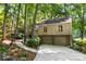 Charming home nestled in the trees, featuring a two-car garage and inviting landscaping at 50 Honeysuckle Woods, Lake Wylie, SC 29710