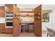 Convenient walk-in pantry with custom shelving, wine fridge and modern appliances at 50 Honeysuckle Woods, Lake Wylie, SC 29710