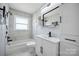 Updated bathroom features modern vanity, bathtub with shower, and stylish fixtures at 502 Kings Mountain St, Clover, SC 29710