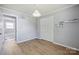 This bedroom has wood-look flooring, a closet, a shelf, and light gray paint at 502 Kings Mountain St, Clover, SC 29710
