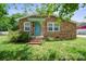 Welcoming brick home featuring an inviting teal door and well-maintained front lawn, perfect for a cozy residence at 502 Kings Mountain St, Clover, SC 29710