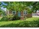 Charming brick home with a bright blue door, landscaped front yard, and inviting curb appeal at 502 Kings Mountain St, Clover, SC 29710