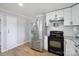 Modern kitchen with stainless steel refrigerator, white cabinets, and wood flooring at 502 Kings Mountain St, Clover, SC 29710