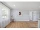 Bright living room featuring large window with sheer curtains and hardwood floors at 502 Kings Mountain St, Clover, SC 29710