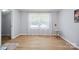 This living room has wood-look flooring, light gray paint, white trim, and a window with sheer curtains at 502 Kings Mountain St, Clover, SC 29710