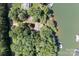 Aerial view of a lakefront property nestled amongst lush trees and featuring a private dock at 505 Kemp Rd, Mooresville, NC 28117