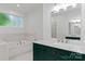Elegant bathroom features marble countertops, tile floor, and a built-in tub at 505 Kemp Rd, Mooresville, NC 28117