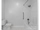 Clean bathroom with toilet, shower and tub combination, and white tiles at 505 Kemp Rd, Mooresville, NC 28117