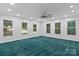Spacious bedroom with many windows, recessed lighting, and teal carpeting at 505 Kemp Rd, Mooresville, NC 28117