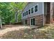 Side view of the home featuring a brick foundation and beautiful windows and sliding doors at 505 Kemp Rd, Mooresville, NC 28117