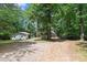 Wide shot of the backyard and the detached garage on a sunny day at 505 Kemp Rd, Mooresville, NC 28117