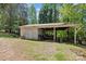 A partial view of a shed with a garage and carport area in a backyard at 505 Kemp Rd, Mooresville, NC 28117