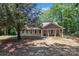 Charming home with large windows, a covered porch, and mature trees providing shade at 505 Kemp Rd, Mooresville, NC 28117