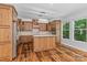 Spacious kitchen featuring stainless steel appliances, wooden cabinetry, and stylish lighting at 505 Kemp Rd, Mooresville, NC 28117