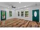 Bright living room featuring hardwood floors, natural light, and a green front door at 505 Kemp Rd, Mooresville, NC 28117