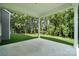 Covered patio with concrete slab overlooking a green lawn and wooded area at 5103 Heathland Dr # 50, Charlotte, NC 28215